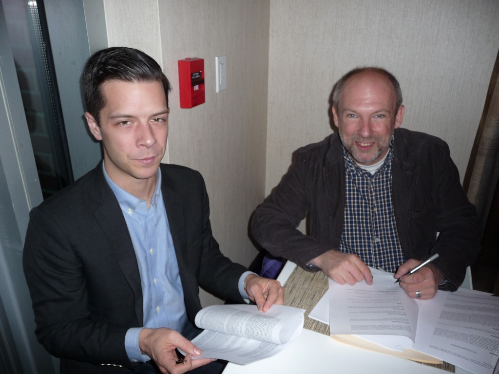 Signing the contracts for THE SACRED WOODS at World Fantasy 2014 (Arlington, Virginia) with my tremendous agent Eddie, whose efforts brought the deal about.